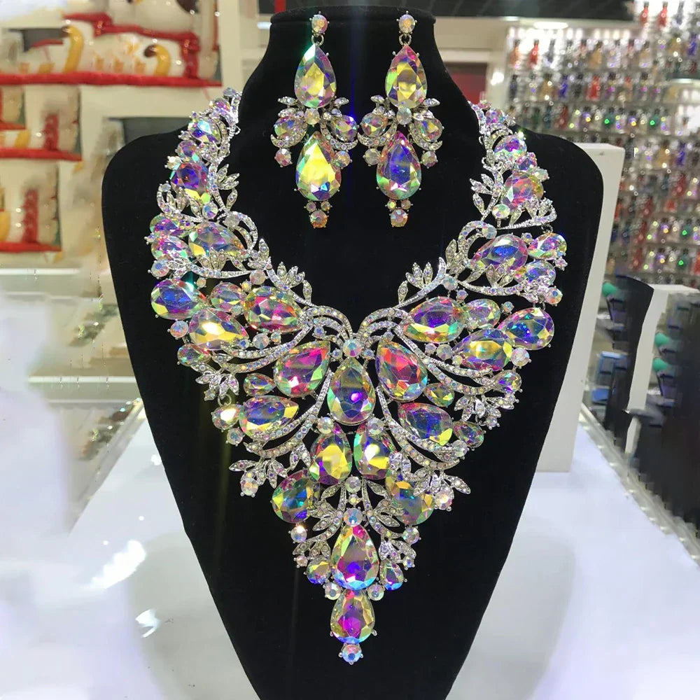 Ornate crystal necklace and matching earrings set with iridescent gemstones.