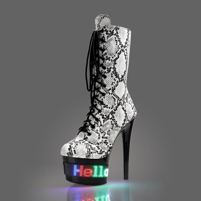 High-heeled platform boot with snakeskin pattern and illuminated ’Hello’ text on the sole.