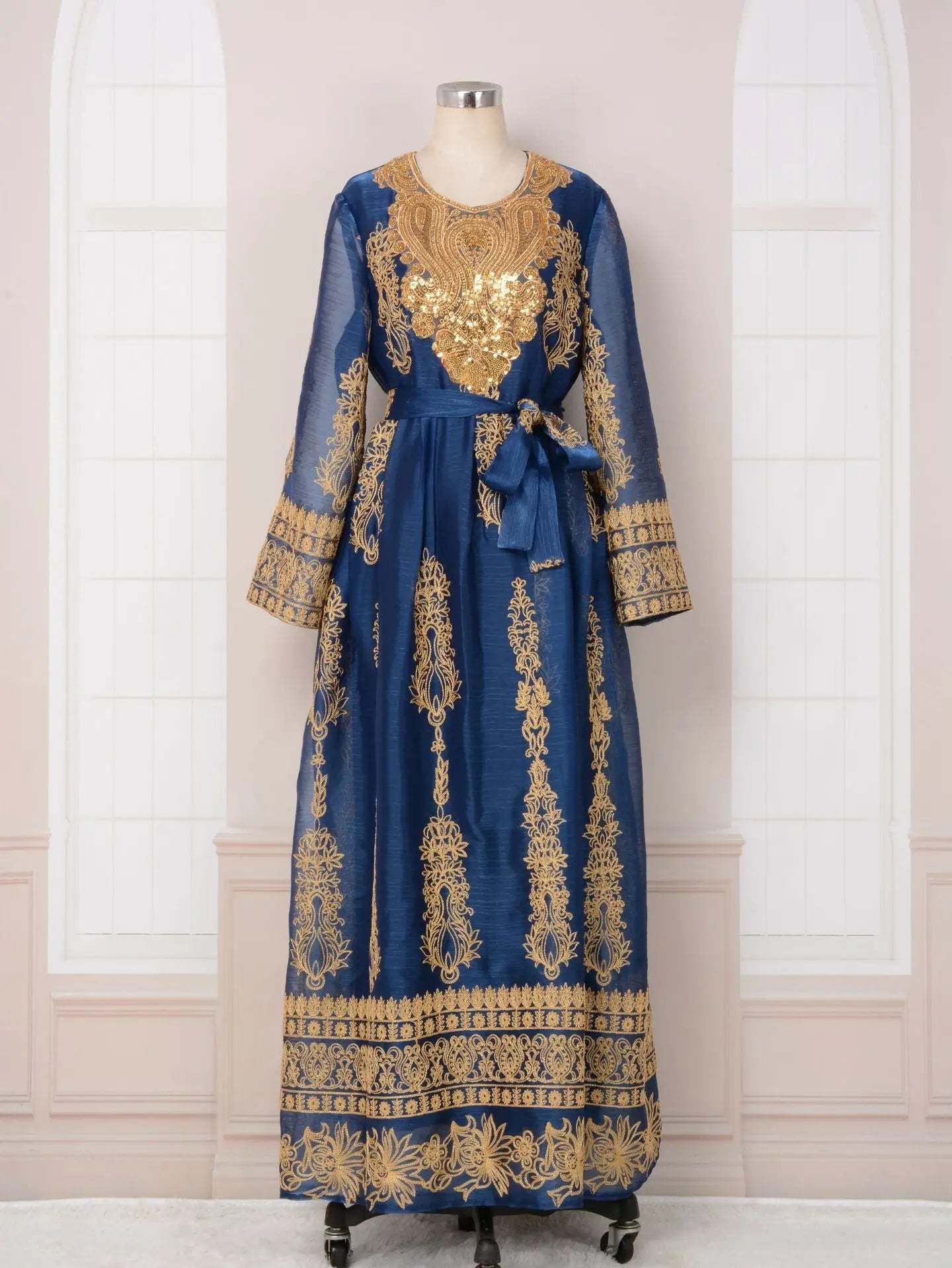 Ornate blue and gold traditional dress with long sleeves and intricate embroidery.