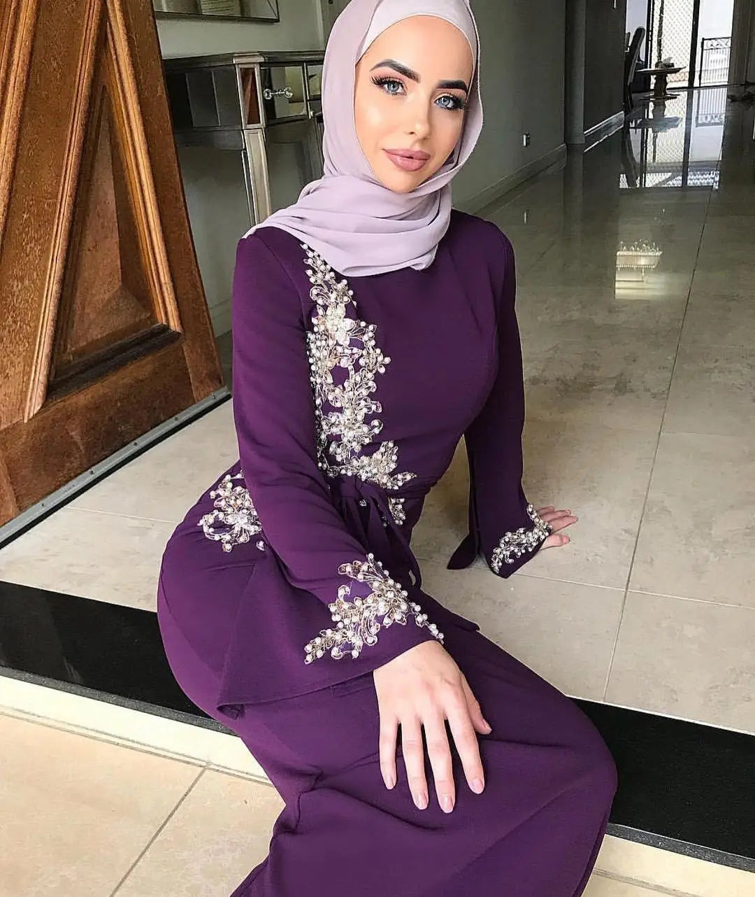 Purple Muslim embroidered dress with floral details and light pink hijab for stylish ladies.