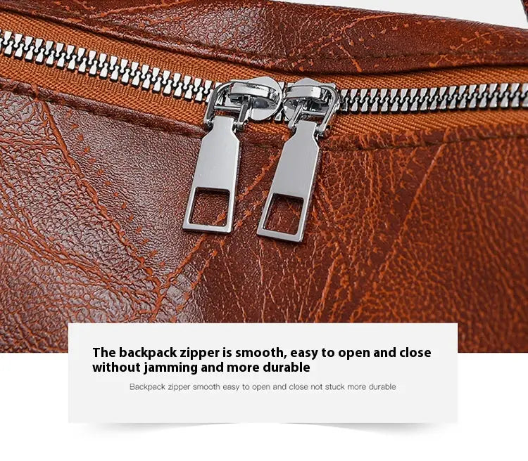 Double metal zipper pulls on soft leather backpack in brown for women.