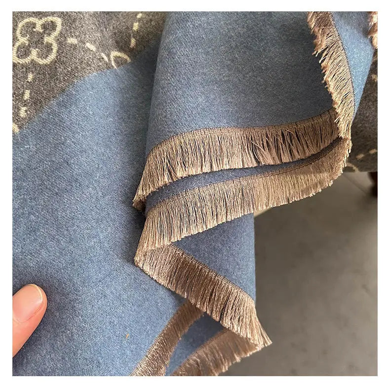 Blue fabric with brown fringe on Exquisite Faux Cashmere Sunflower Shawl for luxury.