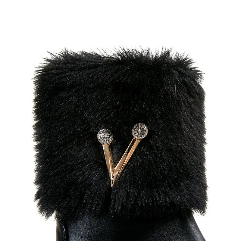 Black furry boot with V-shaped metallic pins and crystals for ladies winter style.