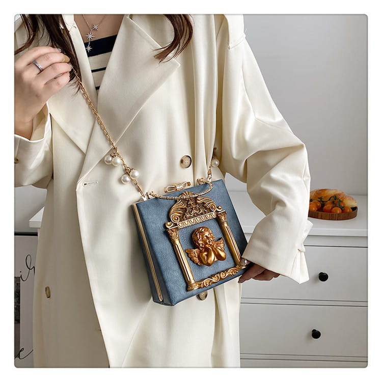 Ornate blue shoulder chain bag with gold floral embellishments and chic design.