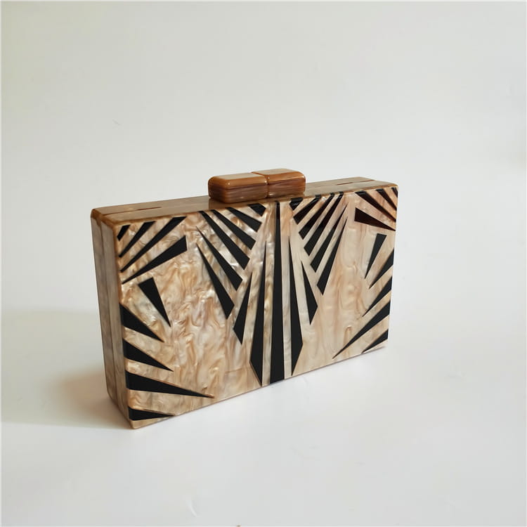 Wooden clutch purse with art deco geometric patterns in black and natural tones.