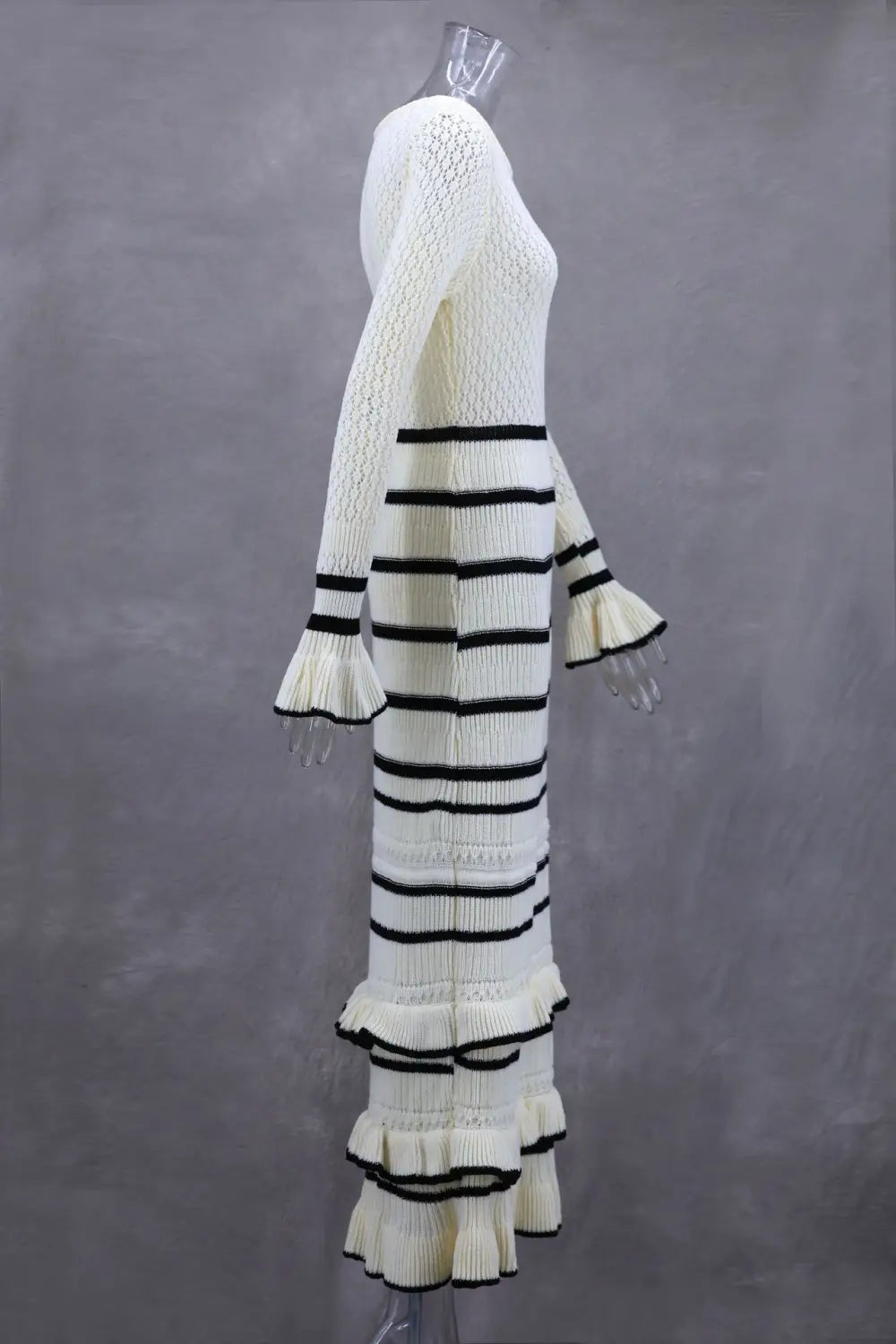 White knitted dress with black stripes and ruffles, perfect for a stylish slim fit look.