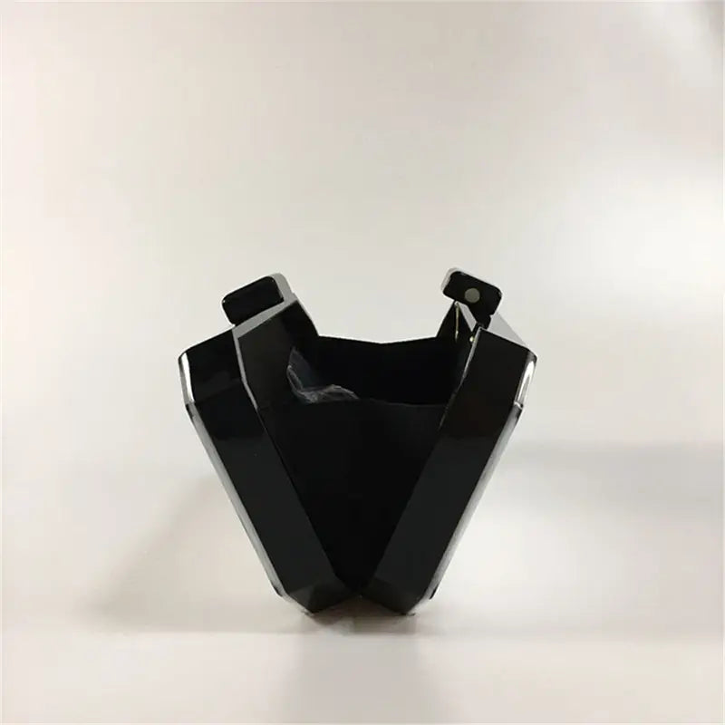 Black plastic face mask beside Art Deco Design Womens Acrylic Evening Bag with Geometric Clutch.