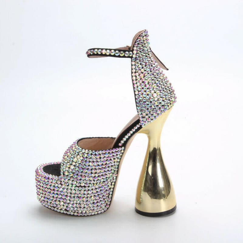 Glittery high-heeled platform shoe with an unusually shaped gold heel.