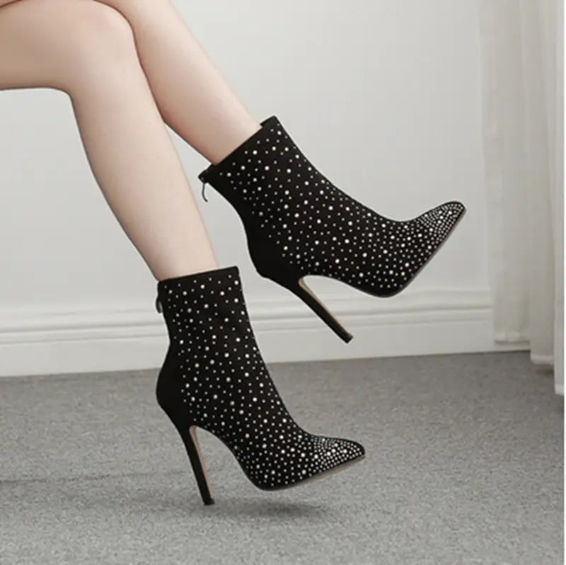 Ladies suede rhinestone pointed toe short boots with stiletto heels and sparkly design.