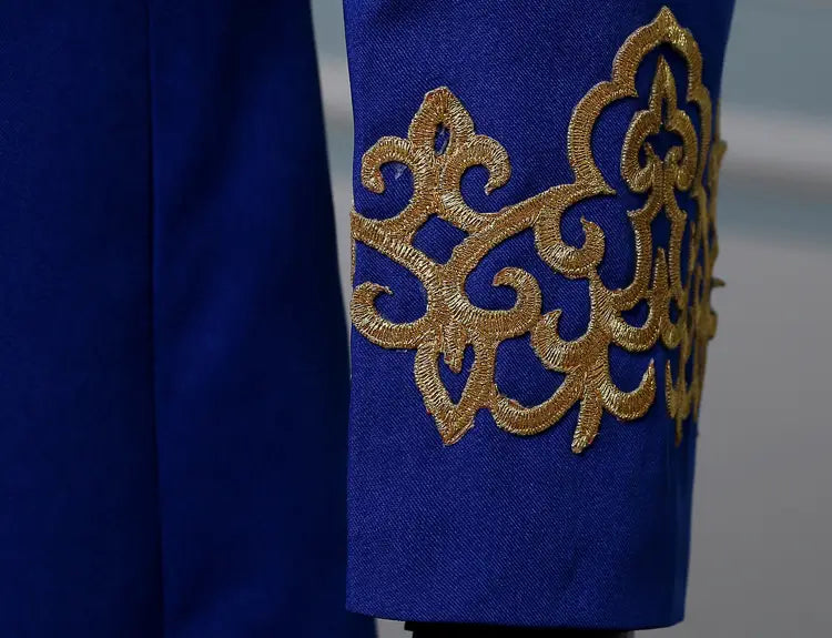 Royal blue fabric with gold embroidery on a Pleasures and Sins double-breasted jacket.