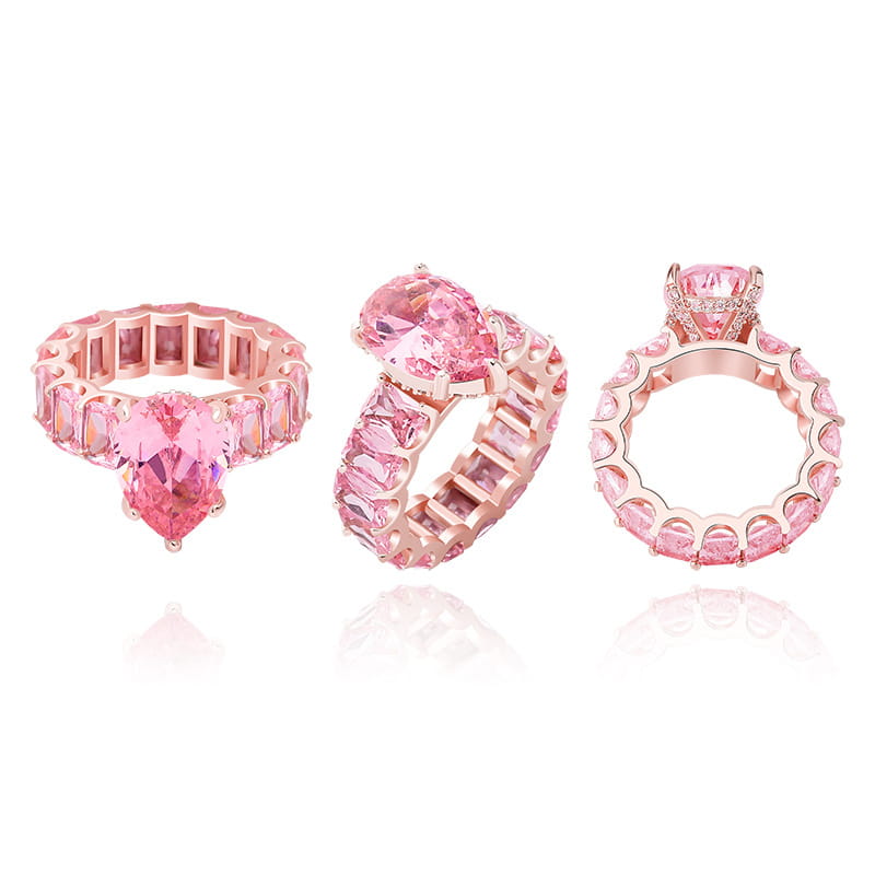 Three rose gold rings with pink heart and rectangular gemstones for a bling water drop pinky look.