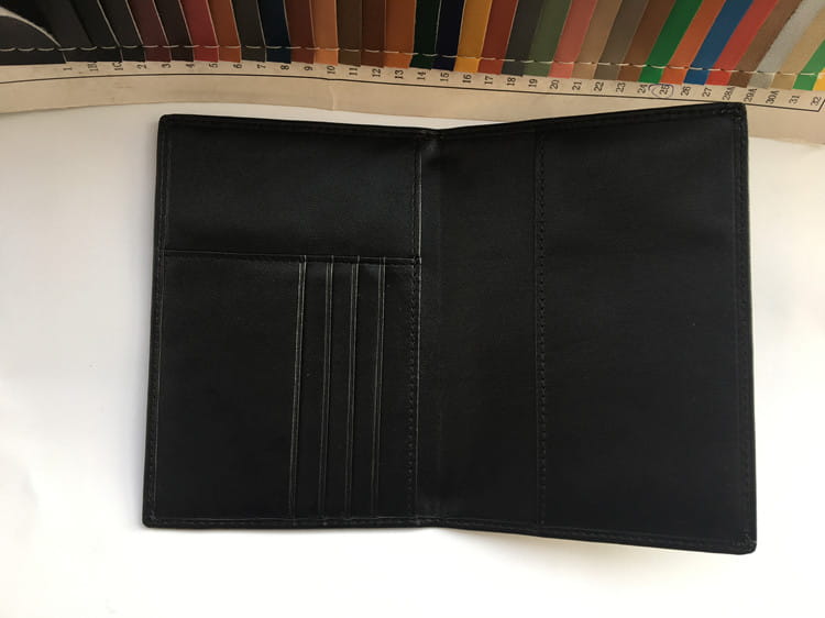 Stylish Black Leather Travel Wallet with RFID Protection and card slots for travel essentials.