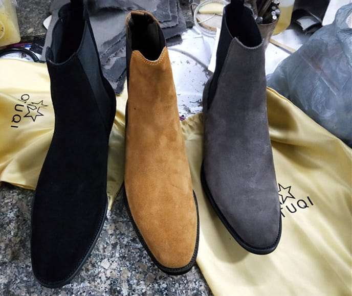 Three stylish Suede Pointed Toe High-Top Chelsea Boots for Men in black, tan, and grey.