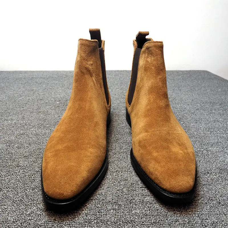 Pair of tan suede pointed toe high-top Chelsea boots for men with elastic side panels.