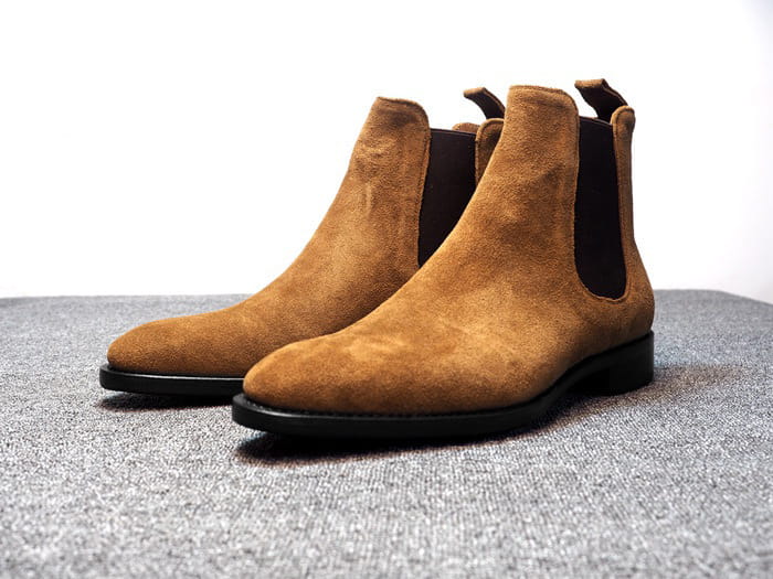 Tan suede pointed toe high-top Chelsea boots for men with elastic side panels.