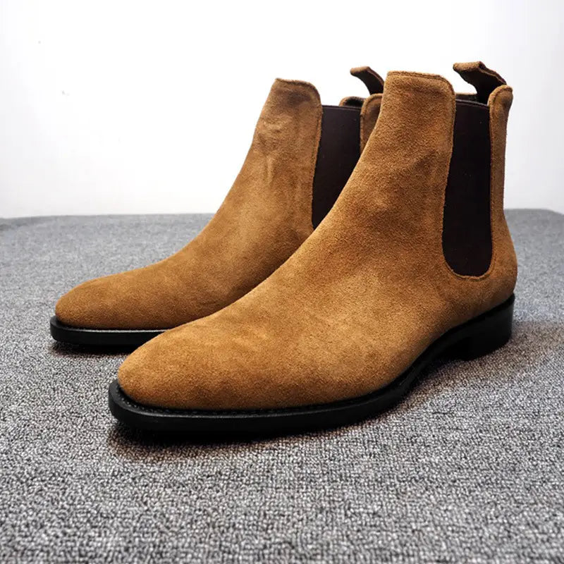 Tan suede pointed toe high-top Chelsea boots for men with elastic side panels.