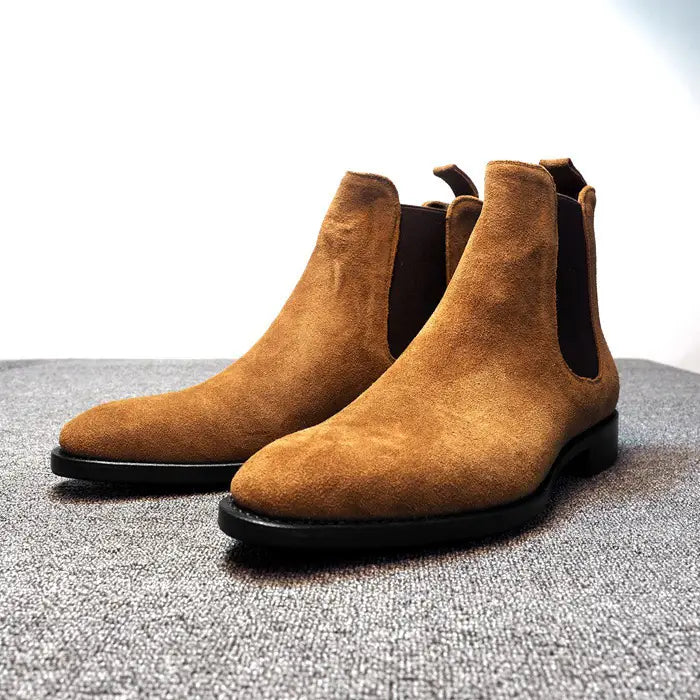 Tan suede pointed toe high-top Chelsea boots for men with elastic side panels.