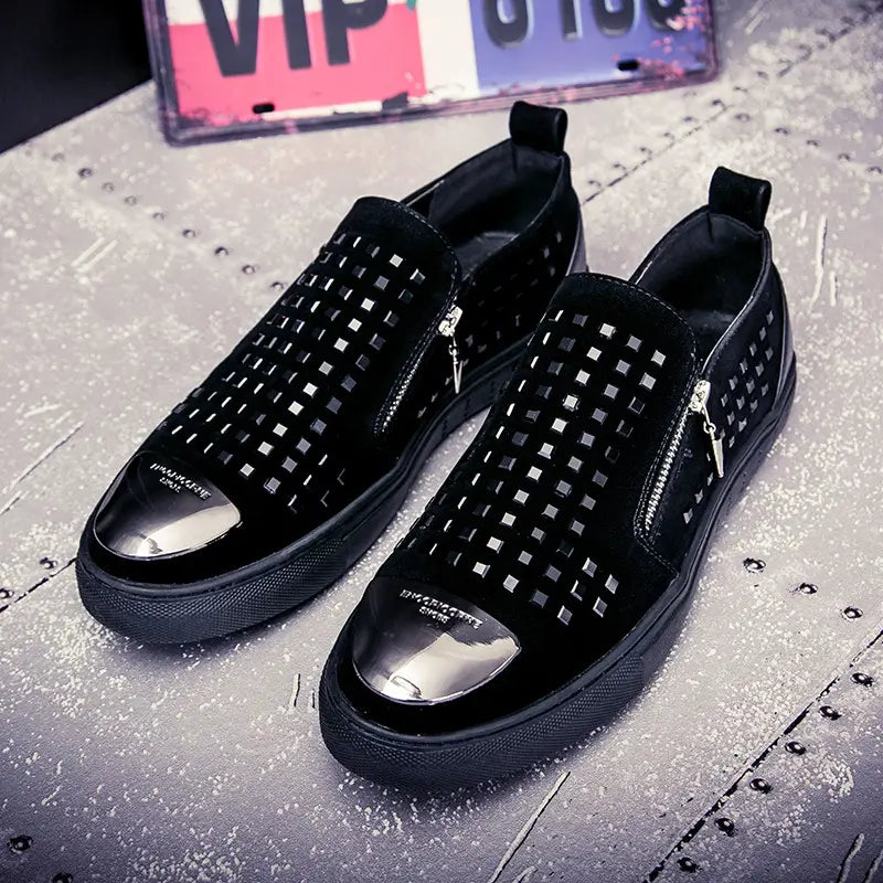 Black studded slip-on sneakers with metallic toe caps for a bold British style look.