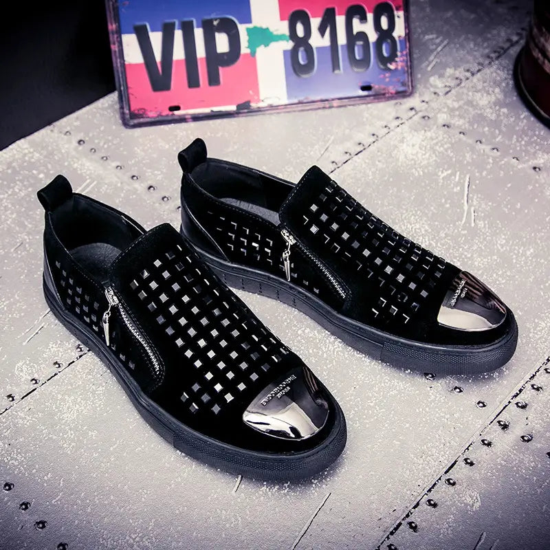 Black studded slip-on sneakers with metallic toe caps for bold British style rhinestone fashion.