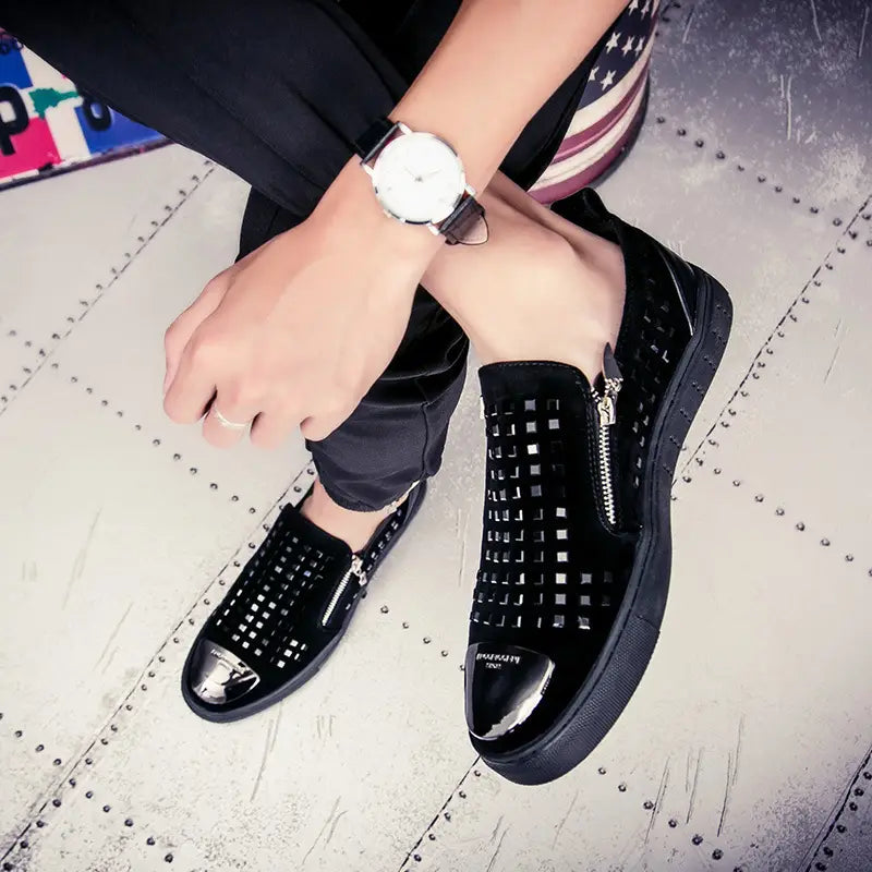 Black patent leather sneakers with zippers and studs for a bold British style rhinestone look.