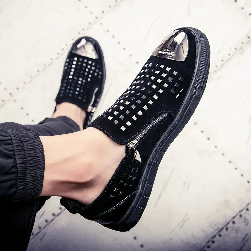 Black suede sneaker with metallic studs and zipper, perfect for rhinestone studded fashion.