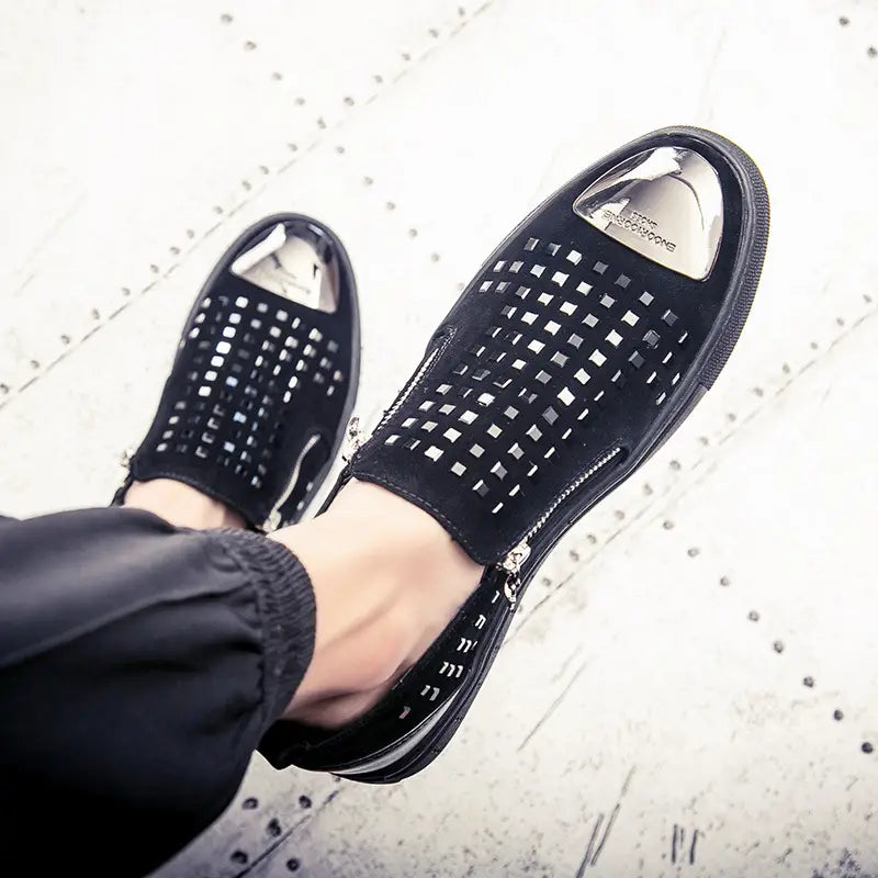 Black perforated slip-on sneakers with metallic toe caps for bold British style rhinestone fashion.