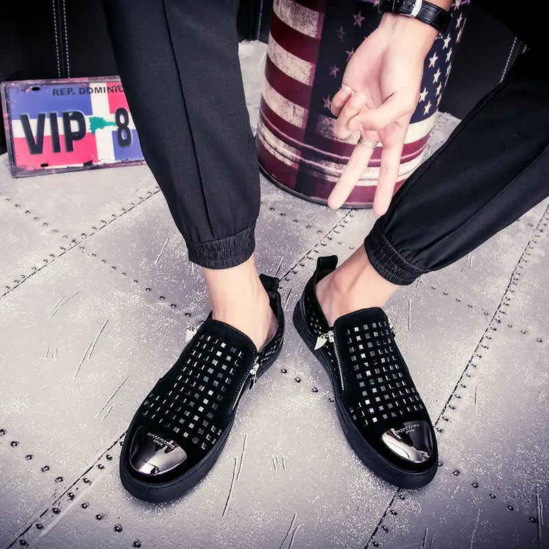 Black studded slip-on dress shoes with patent leather caps for bold British style rhinestone fashion.