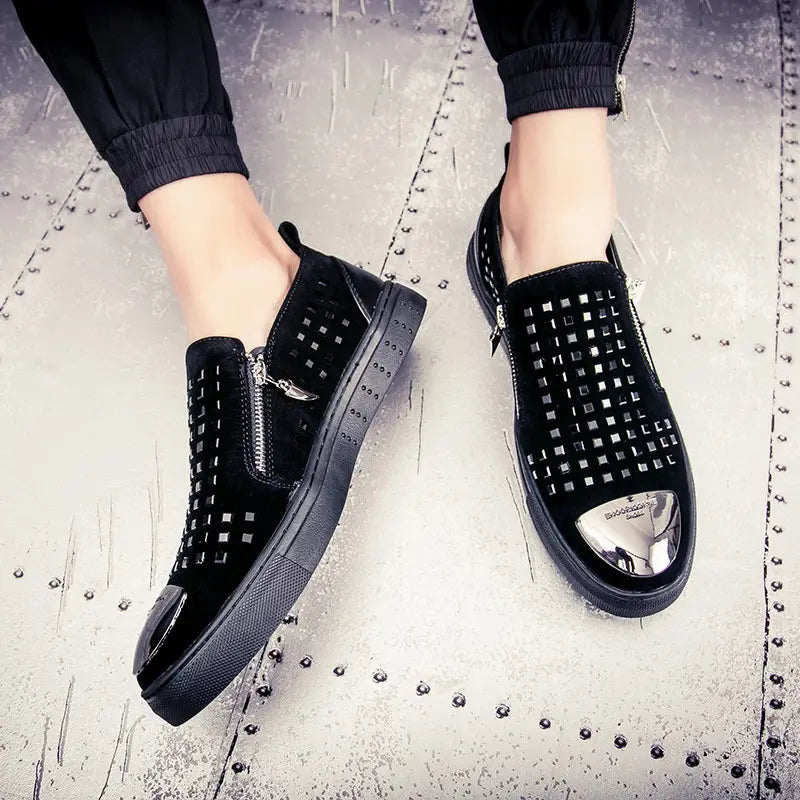 Black studded slip-on sneakers with metallic toe caps for bold British style rhinestone fashion.