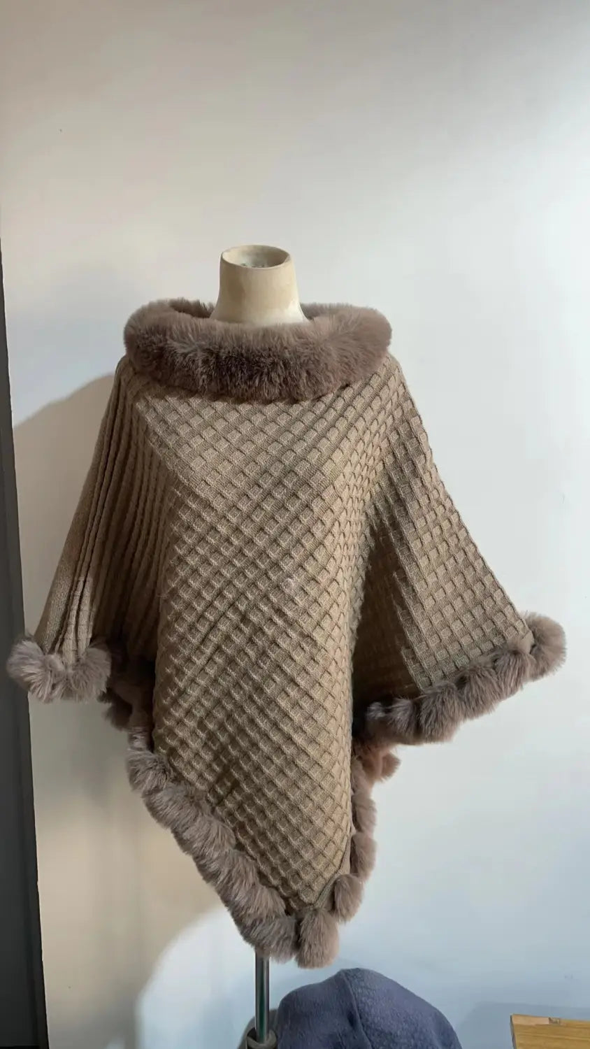 Beige knitted shawl cape poncho with a chic faux fur collar and stylish trim.