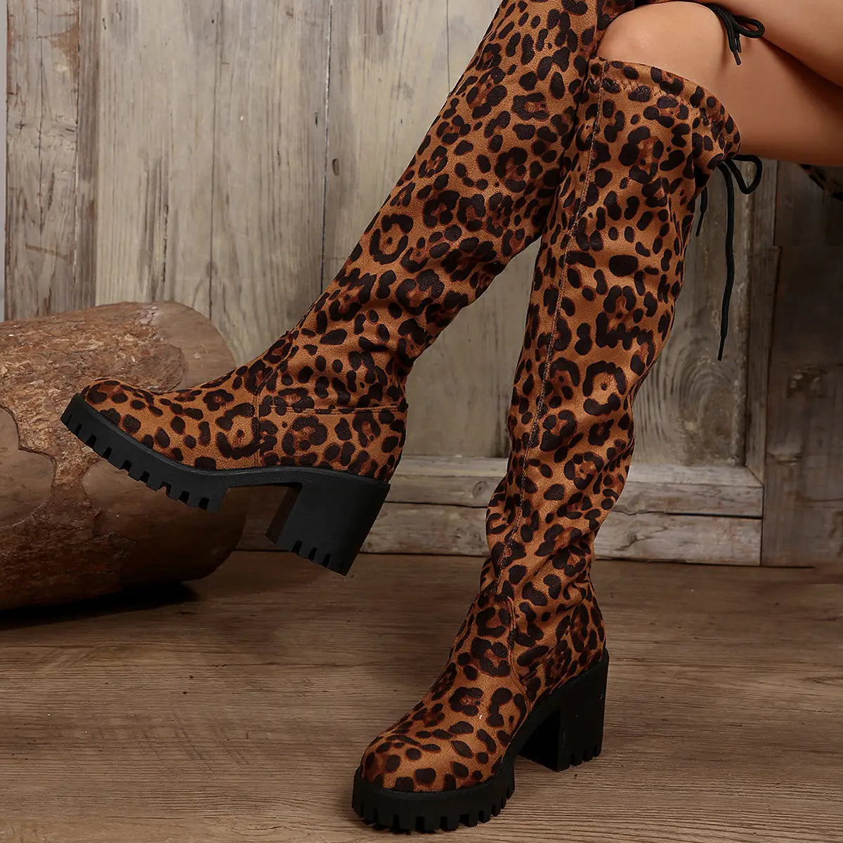 Leopard print knee boots with chunky heels for a trendy and stylish look.