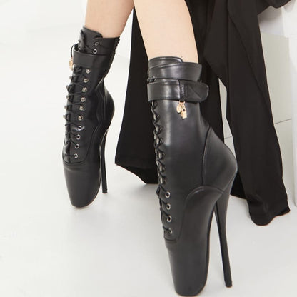 Pair of extreme high-heeled black leather ankle boots with laces and ankle straps.