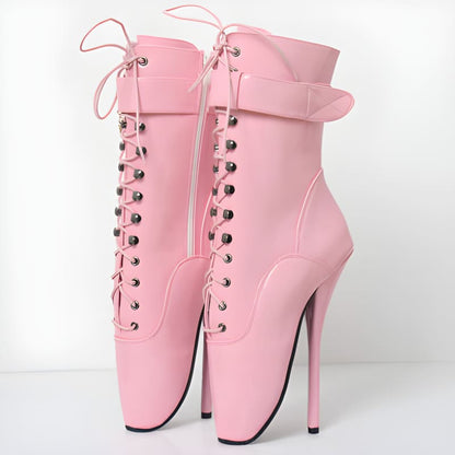 Pair of pink high-heeled ankle boots with laces and straps.