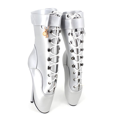 White ballet-inspired stiletto boots with lace-up fronts and extremely high heels.