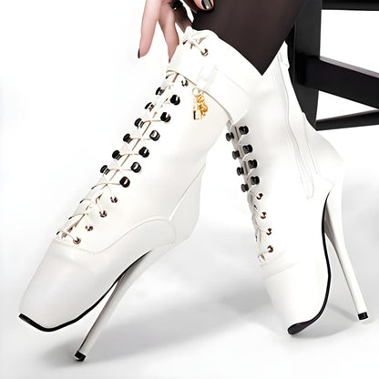 White high-heeled boots with lace-up front and metal studs.