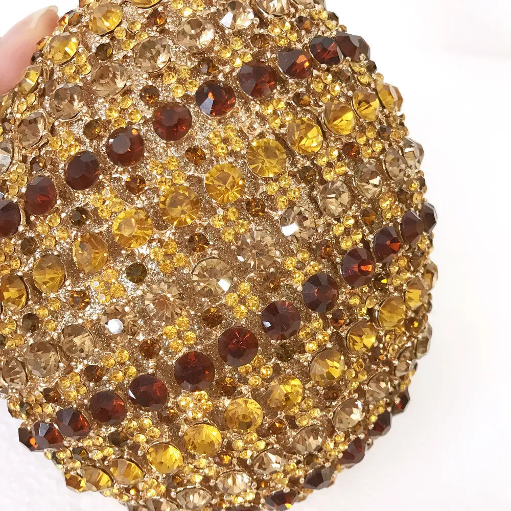 Ornate brooch with amber and crystal rhinestones on Pineapple Shaped Crystal Diamante Bag.