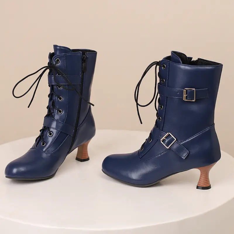 Navy blue mid heel lace-up boots with buckles and curved wooden heels for a stylish look.