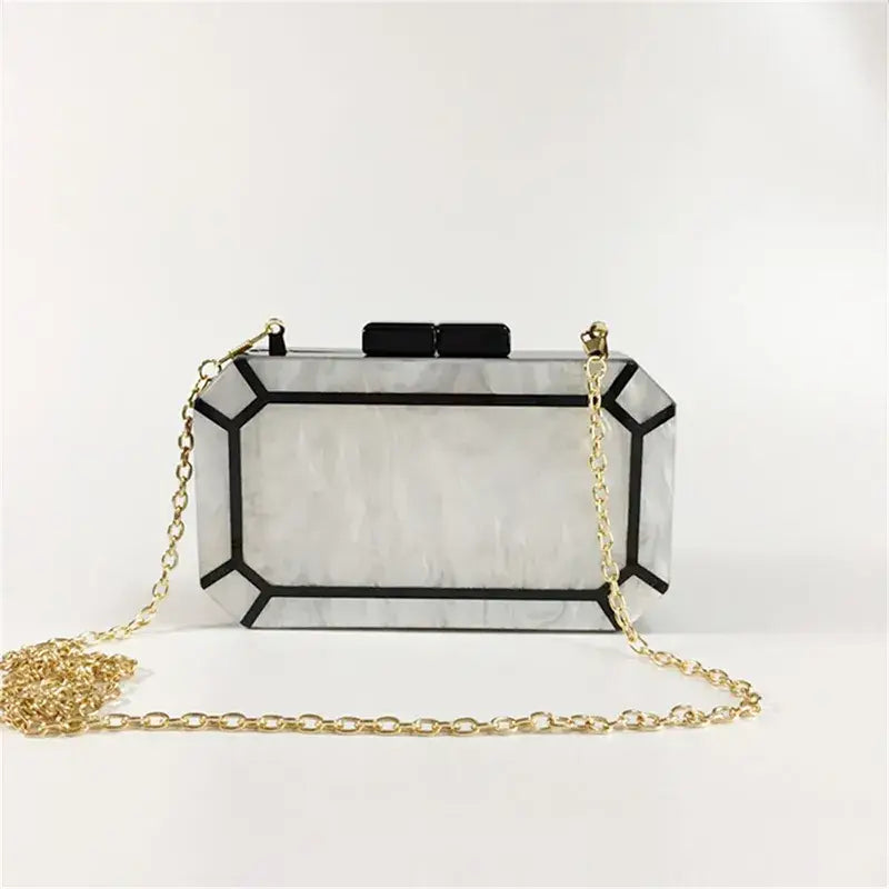 Art Deco Design Womens Acrylic Evening Bag with geometric style and gold chain strap.