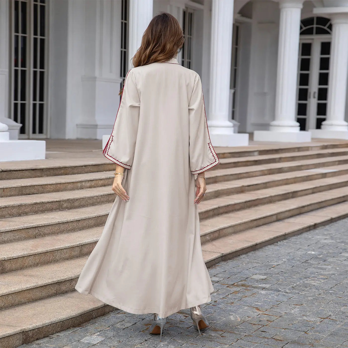 Flowing beige maxi dress with embroidered bell sleeves, perfect Muslim Middle East style.