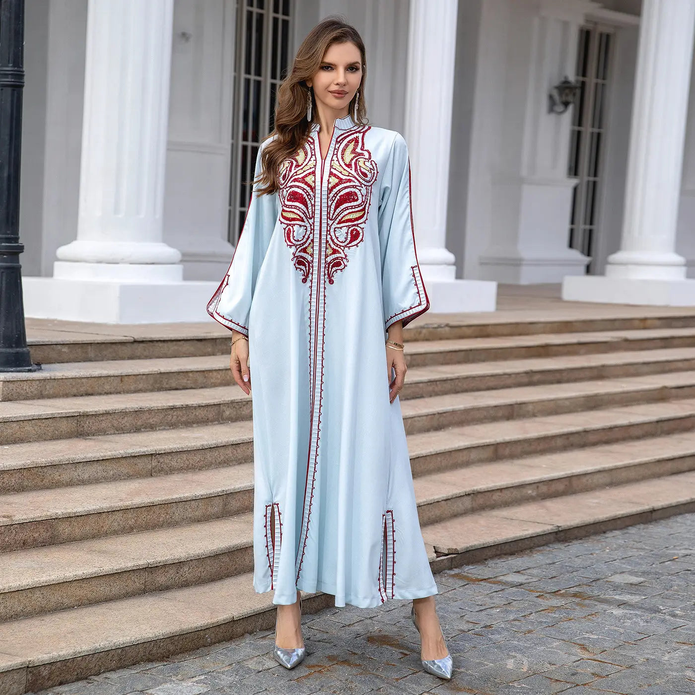 Light blue Muslim Middle East Embroidery Kaftan with red details and long sleeves.