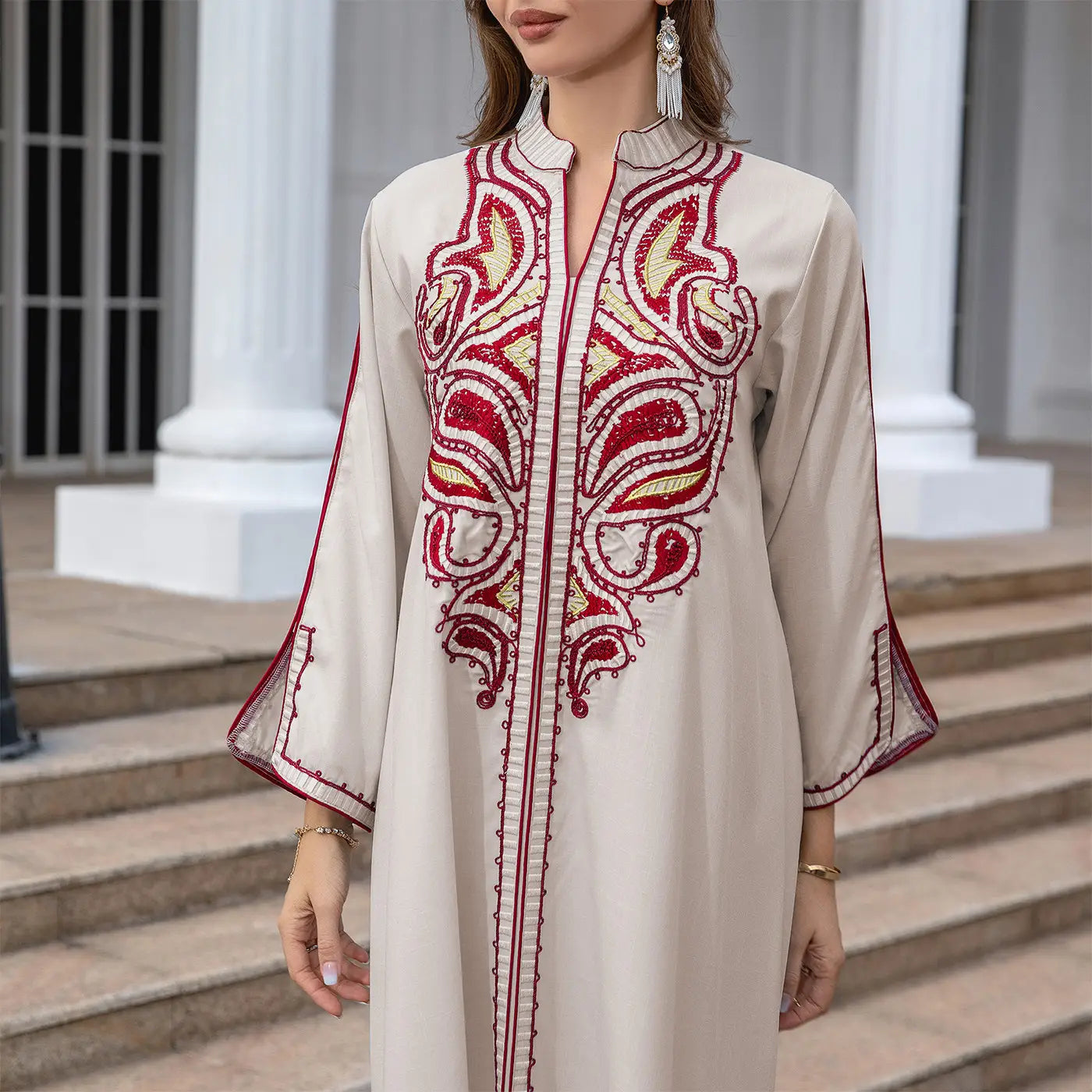 Cream-colored Muslim Middle East embroidery kaftan dress with red patterns.