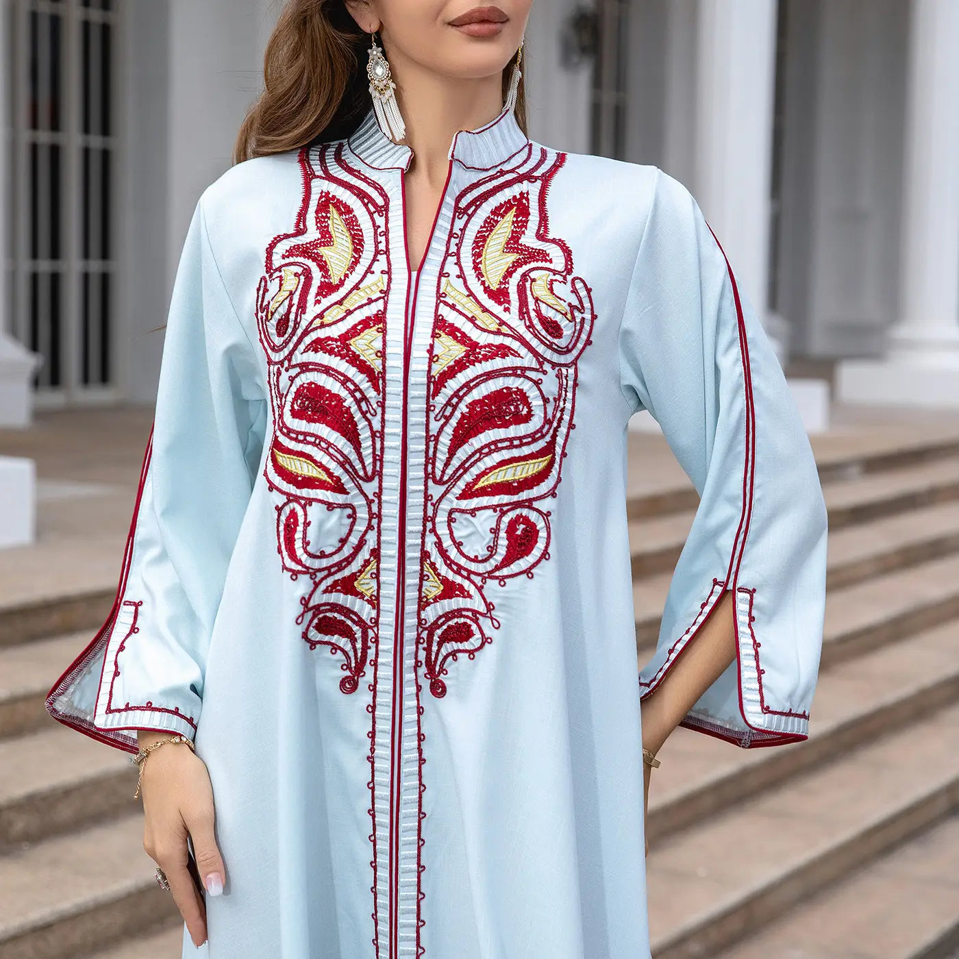 Light blue Ornate Muslim Middle East Embroidery Kaftan-style Dress with red and gold details.