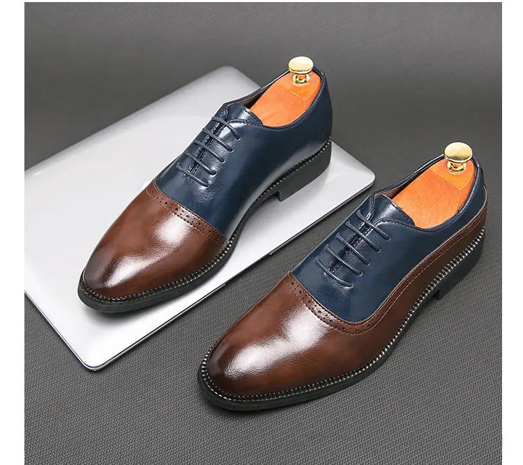 Two-tone color block brogue style shoes in navy blue and brown for men’s business wear.