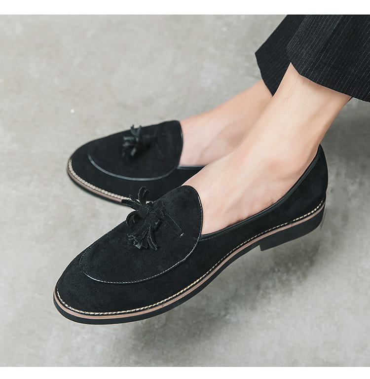 Black suede tassel loafer with contrast stitching for the latest mens fashion trend.