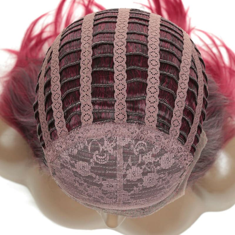 Wig cap with pink hair attached, showing the interior mesh structure.