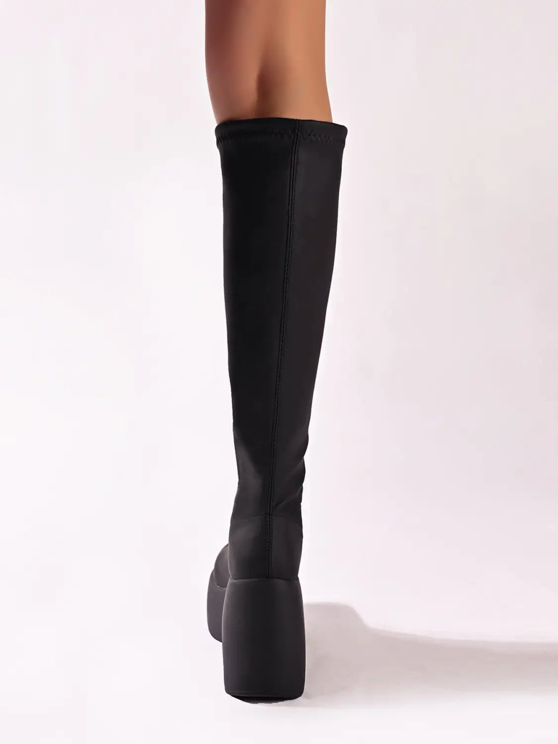 Black knee-high chunky platform elasticated boots with a stylish chunky heel.