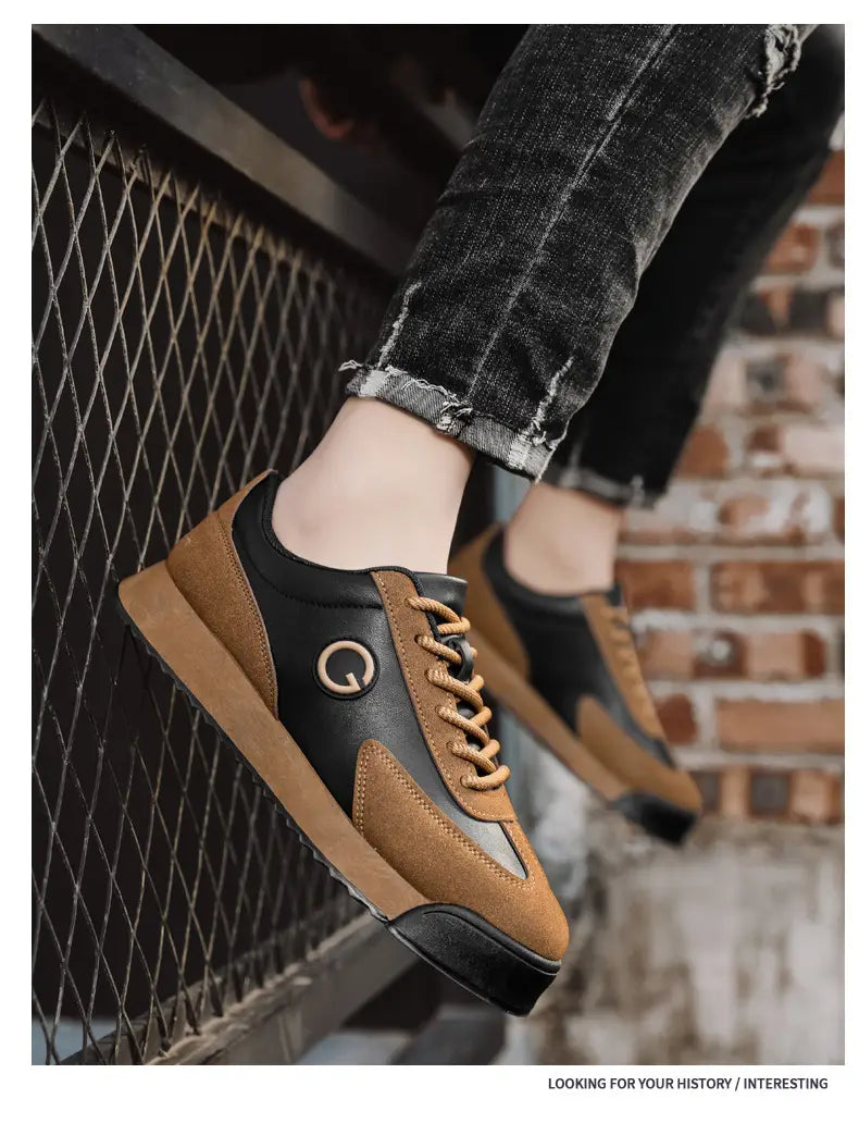 Brown and black leather casual flat trainer shoes with tan laces and Q logo.