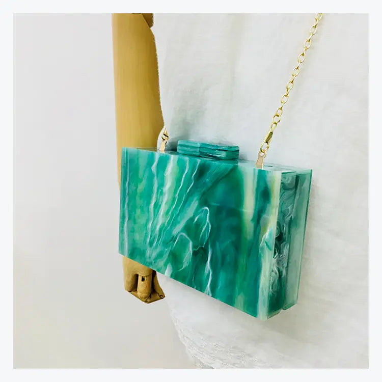 Turquoise acrylic clutch purse with marbled pattern, perfect for an evening handbag luxury.