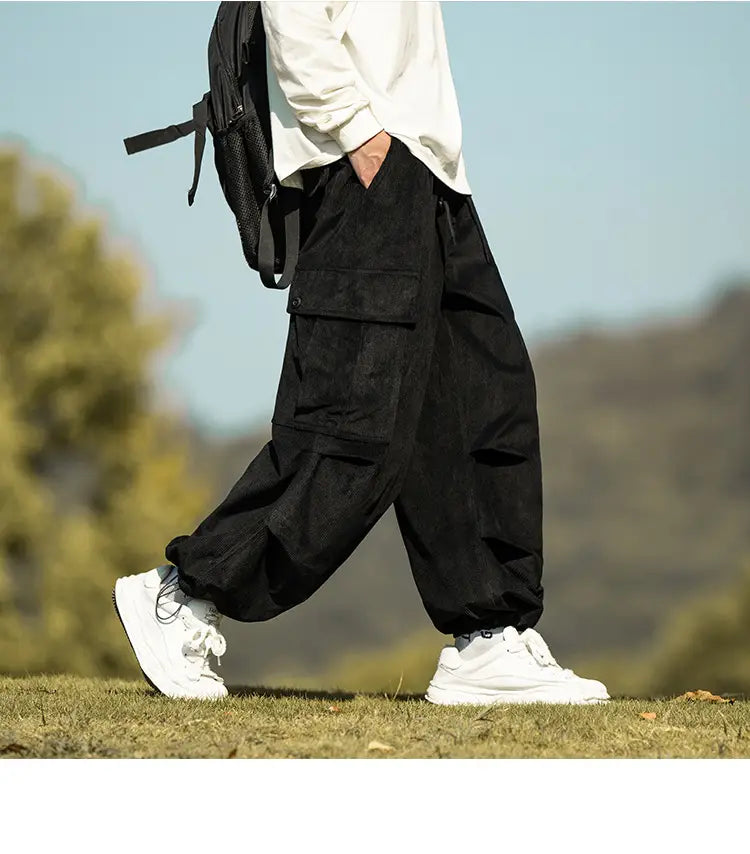 Stylish Men’s Wide-leg Corduroy Cargo Pants in black with multiple pockets and a baggy fit.