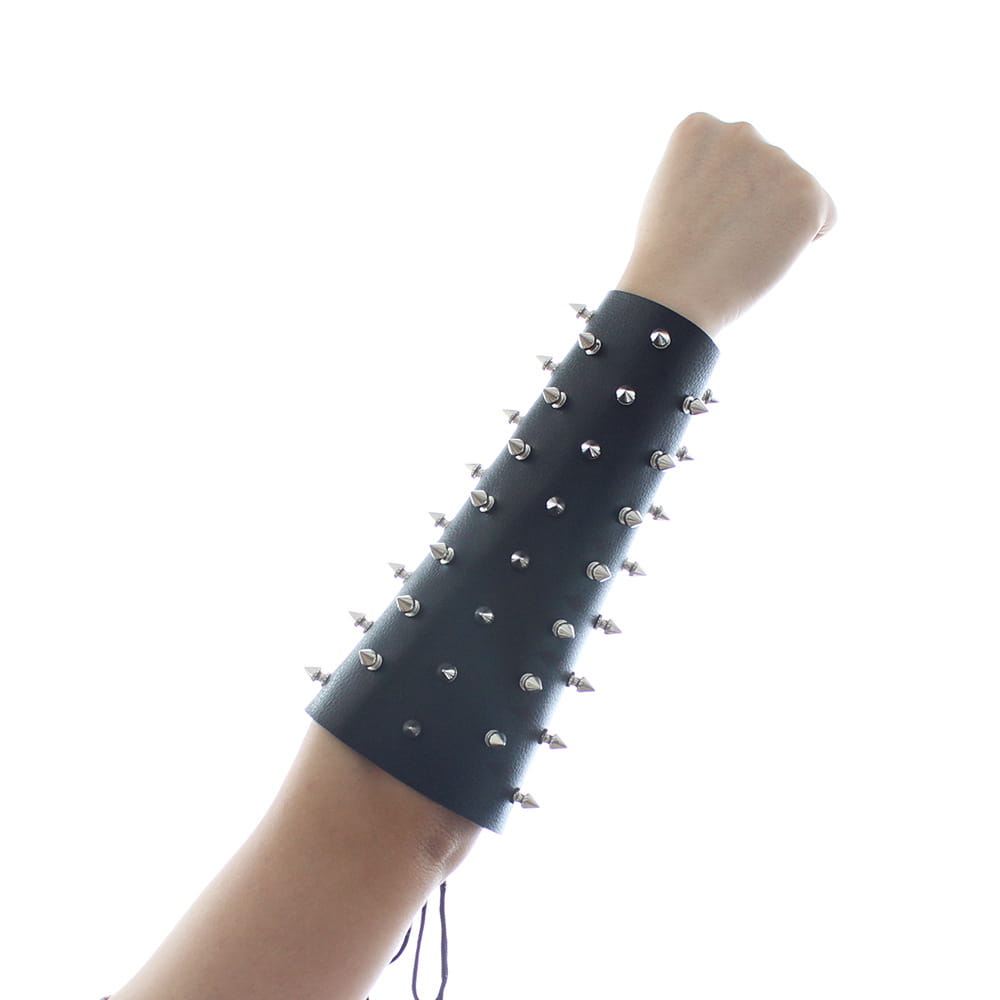 Black leather spiked arm bracer with metal studs for erotic bondage straps and nail armor.