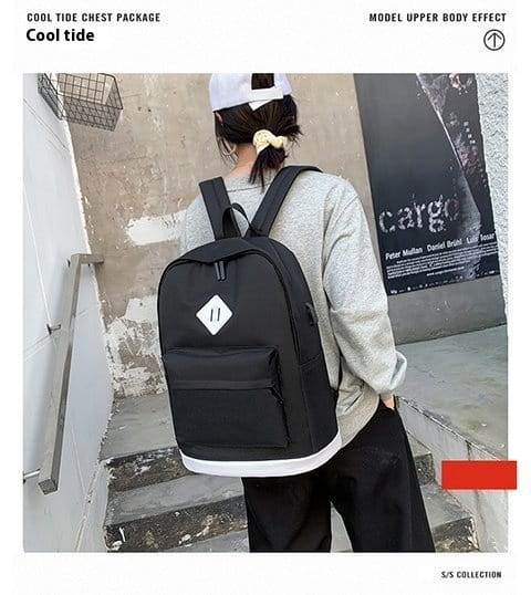 Black large capacity USB backpack computer with white diamond patch for travel.